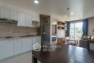Modern open-plan kitchen and living area with natural light and stylish furnishings.