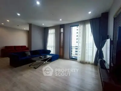 Spacious modern living room with large windows and stylish furniture