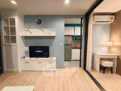Modern living room with open kitchen and stylish decor in a cozy apartment.