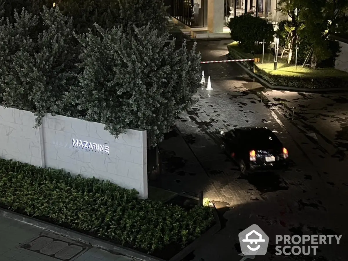 Elegant entrance of Mazarine residential complex with lush greenery and secure gated access.