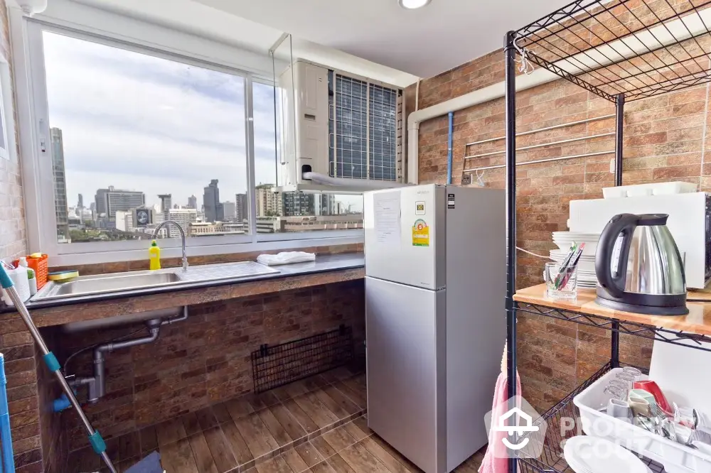 Modern kitchen with city view, featuring stainless steel fridge and open shelving.