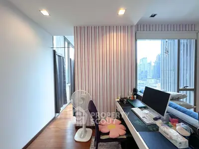 Modern study room with city view, featuring a sleek desk and large window.
