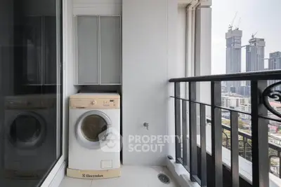 Modern balcony with washing machine and city view in high-rise apartment