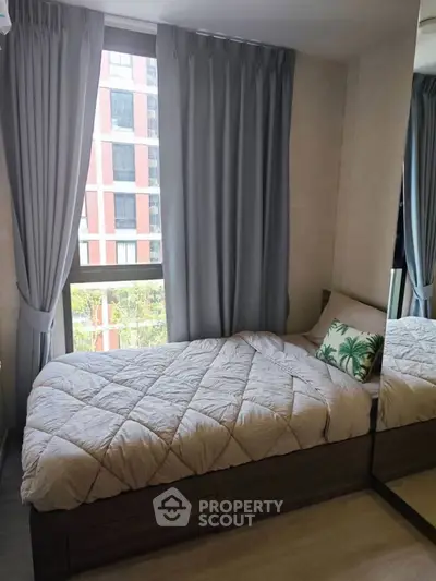 Cozy bedroom with large window and modern decor in urban apartment