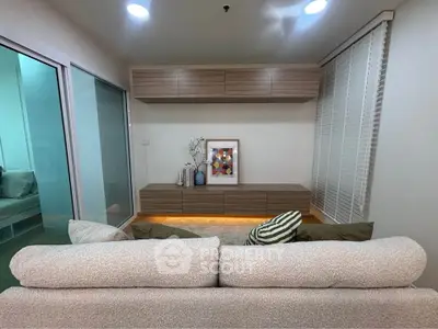 Modern living room with cozy sofa and stylish decor in a contemporary apartment.
