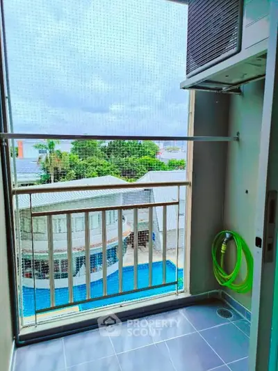 Charming balcony with pool view, perfect for relaxation and enjoying the outdoors.