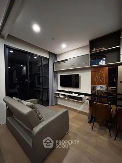 Modern living room with sleek furniture and large window view.