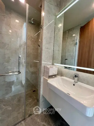 Modern bathroom with glass shower and sleek sink design