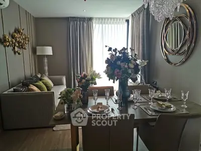 Elegant living room with dining area, featuring chic decor and natural light, perfect for modern living.