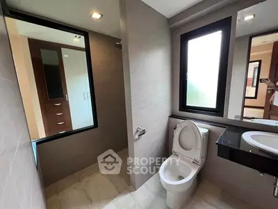 Modern bathroom with sleek design and large mirror in a contemporary home.