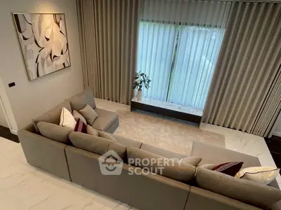 Luxurious living room with stylish sectional sofa and elegant curtains