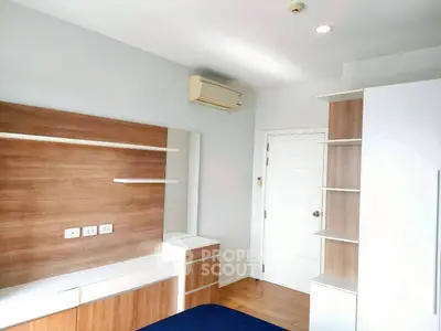 Modern bedroom with built-in wooden shelves and air conditioning unit.