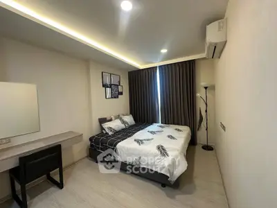 Modern bedroom with stylish decor and natural light, featuring a comfortable bed and sleek furnishings.