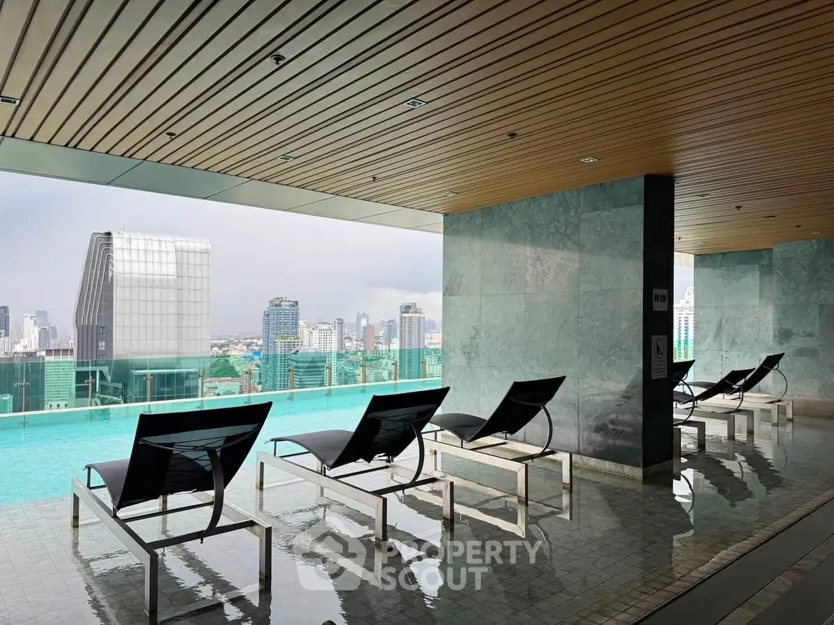 Luxurious rooftop pool with stunning city skyline views and modern lounge chairs.