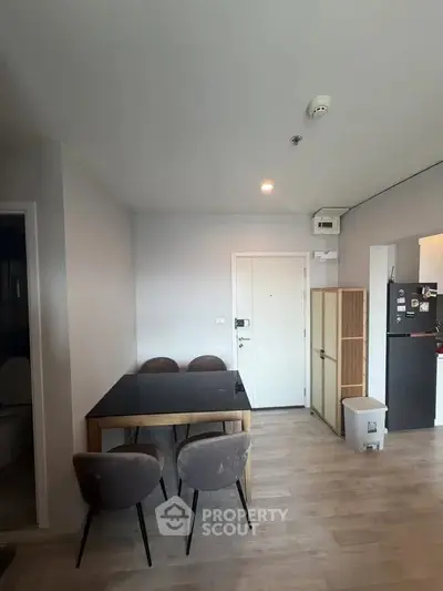 Modern dining area with sleek table and chairs in a stylish apartment interior.