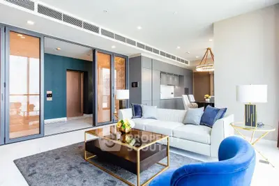 Luxurious modern living room with elegant furniture and open kitchen layout, perfect for stylish urban living.
