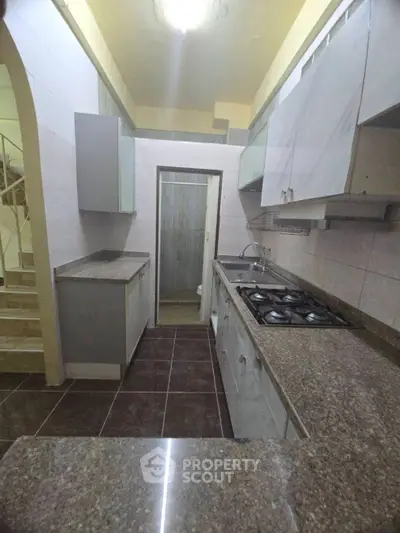 Modern kitchen with gas stove and sleek countertops