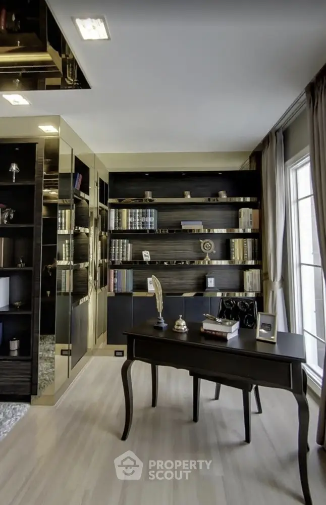 Luxurious home study with elegant dark wood furniture and built-in bookshelves.