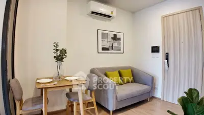 Cozy living room with modern decor and compact dining area