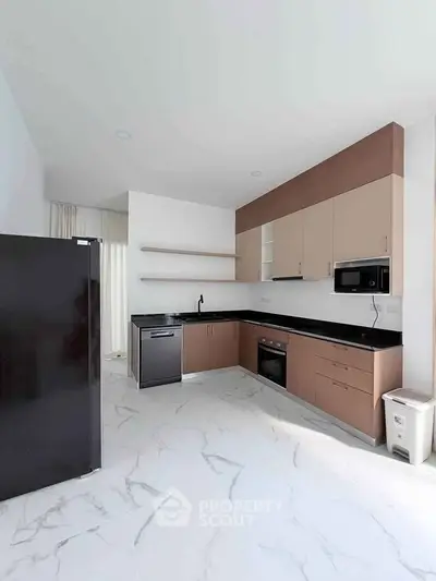 Modern kitchen with sleek cabinetry and built-in appliances in a bright, spacious layout.