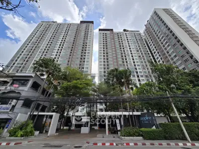 Stunning high-rise residential building with lush greenery and modern architecture.