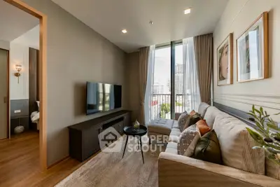 Modern living room with large window and city view, featuring stylish decor and comfortable seating.