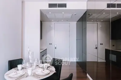 Modern dining area with sleek kitchen design and elegant table setting