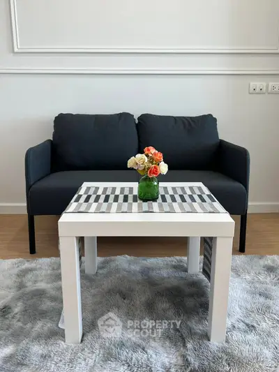 Stylish living room with modern sofa and chic coffee table on plush rug