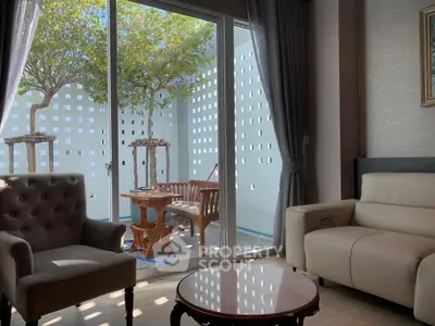 Cozy living room with elegant furniture and view of private garden patio.