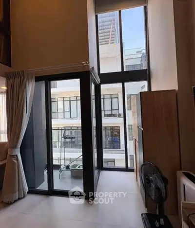 Modern apartment with floor-to-ceiling windows and small balcony