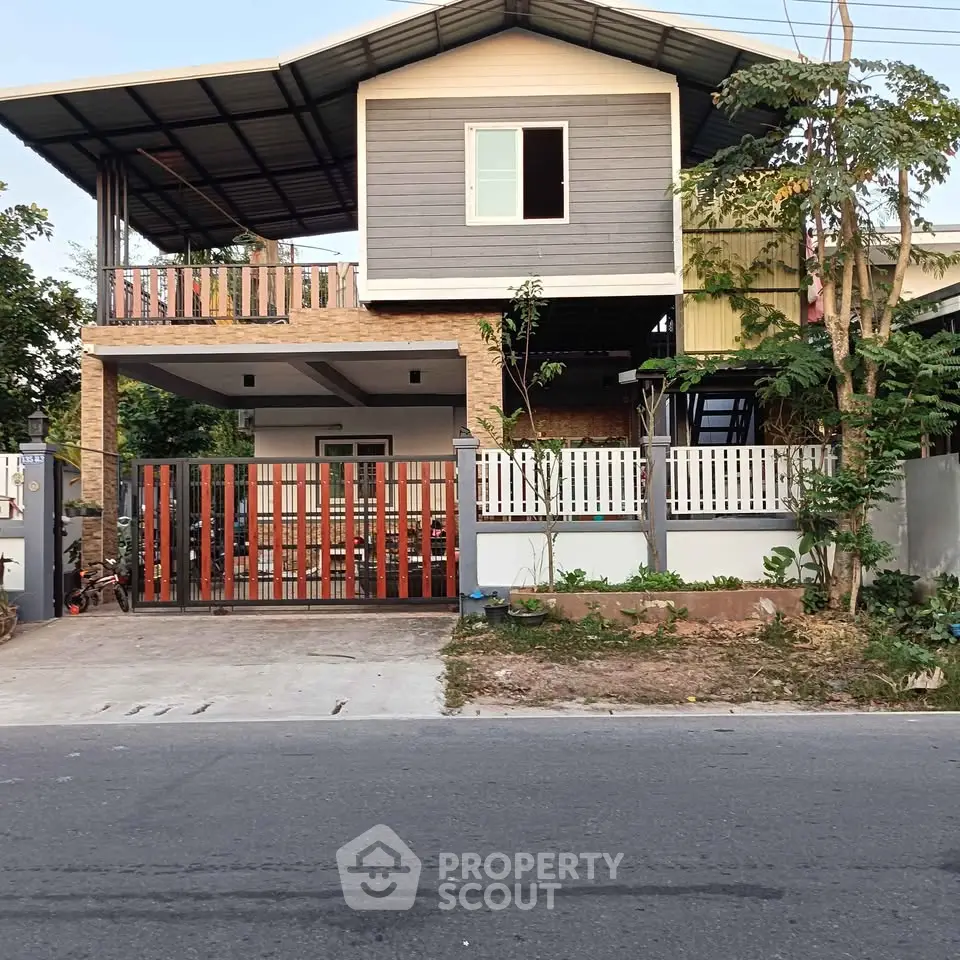 Modern two-story house with spacious balcony and stylish facade, perfect for family living.
