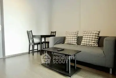 Modern living room with stylish sofa and dining area in open layout apartment.