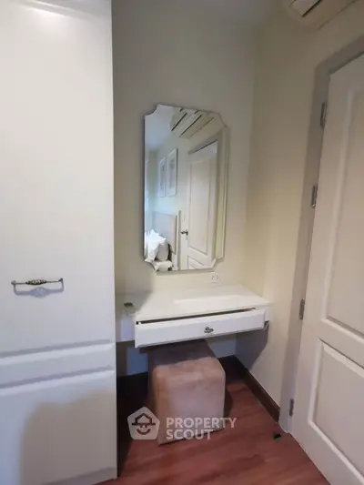 Cozy bedroom corner with elegant vanity and mirror in modern apartment