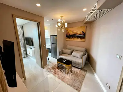 Modern living room with stylish decor and open kitchen layout in a cozy apartment.