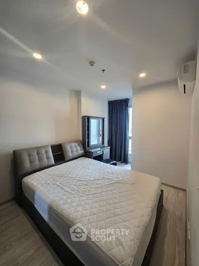 Spacious bedroom with modern furnishings and natural light, perfect for comfortable living.