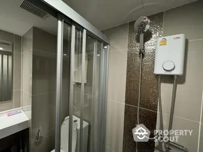 Modern bathroom with glass shower enclosure and water heater