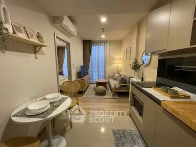 Modern open-plan living room and kitchen with stylish decor and cozy ambiance.