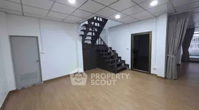 Spacious interior with modern staircase and wooden flooring, ideal for versatile living space.