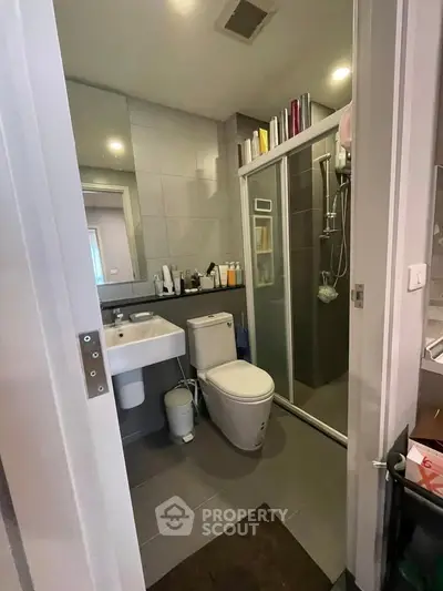 Modern bathroom with sleek design, glass shower, and stylish fixtures in a contemporary home.