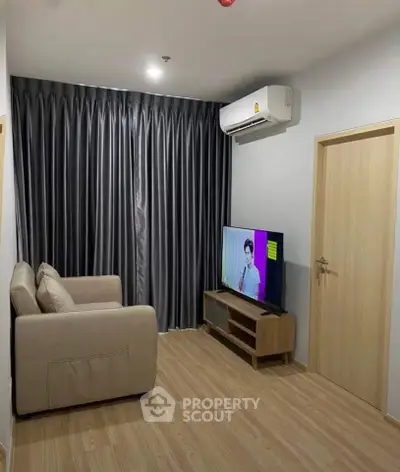 Modern living room with sleek design, featuring a cozy sofa, flat-screen TV, and elegant curtains.