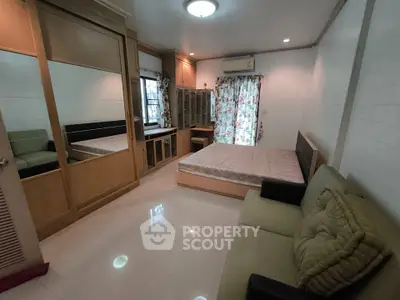 Spacious bedroom with modern furnishings and ample natural light