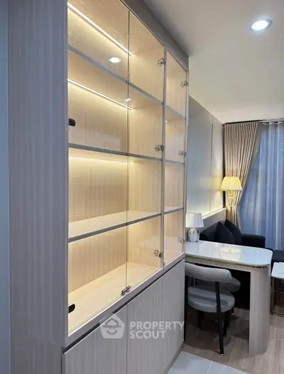 Modern living room with elegant glass cabinet and cozy seating area