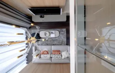 Modern living room with elegant chandelier and cozy sofa in a stylish apartment.