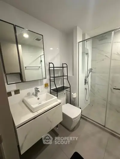 Modern bathroom with sleek fixtures and glass shower enclosure
