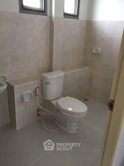 Spacious bathroom with modern fixtures and neutral tiles, perfect for a serene home environment.