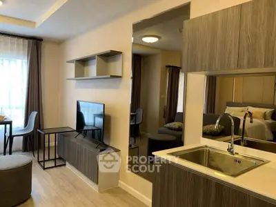 Modern apartment interior with open layout, featuring a cozy living area and stylish kitchen.