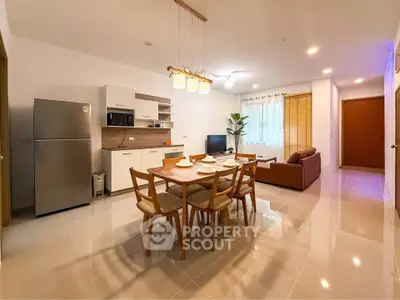 Spacious open-plan living and dining area with modern kitchen and stylish decor.