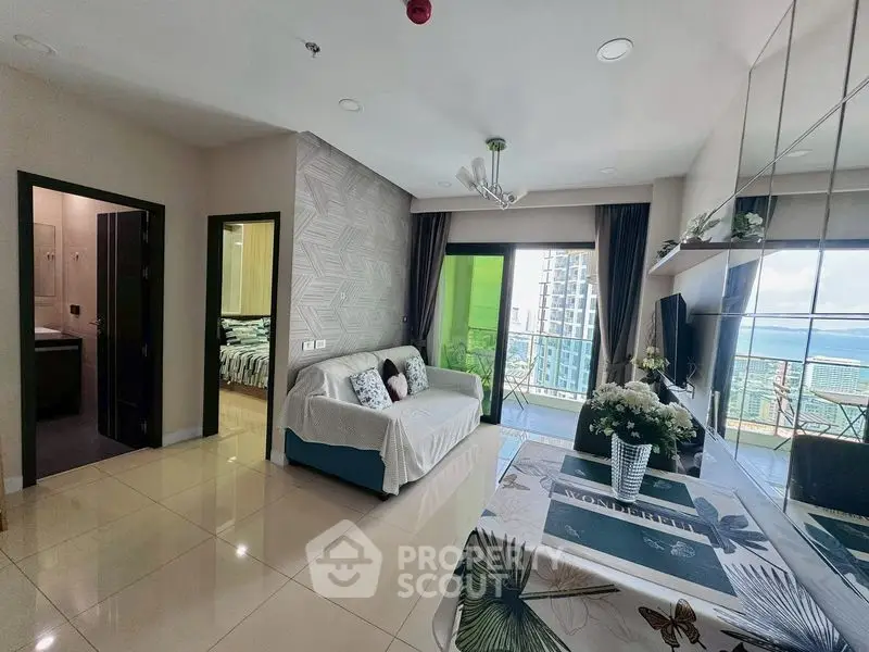 Modern living room with balcony and stunning city view in high-rise apartment