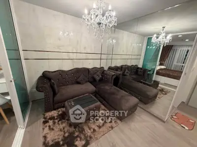 Luxurious living room with elegant chandelier and plush sofa in modern apartment