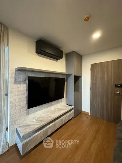 Modern living room with sleek TV unit and wooden flooring